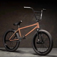 Kink Switch 20 inch BMX bike in astro red photographed at a 45 degree angle in an industrial warehouse