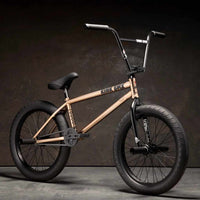 Kink Williams 20 inch BMX bike in mojave bronze photographed at a 45 degree angle in an industrial warehouse