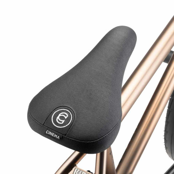 Close up of black Cinema Standard Stealth Pivotal seat on a mojave bronze Kink Williams BMX bike