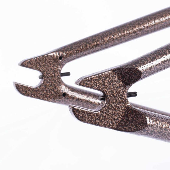 Close-up of a copper vein chain stay  with chain tensioners on a white background