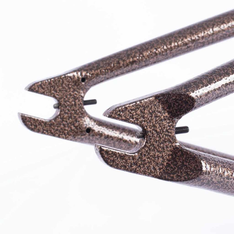 Close-up of a copper vein chain stay  with chain tensioners on a white background