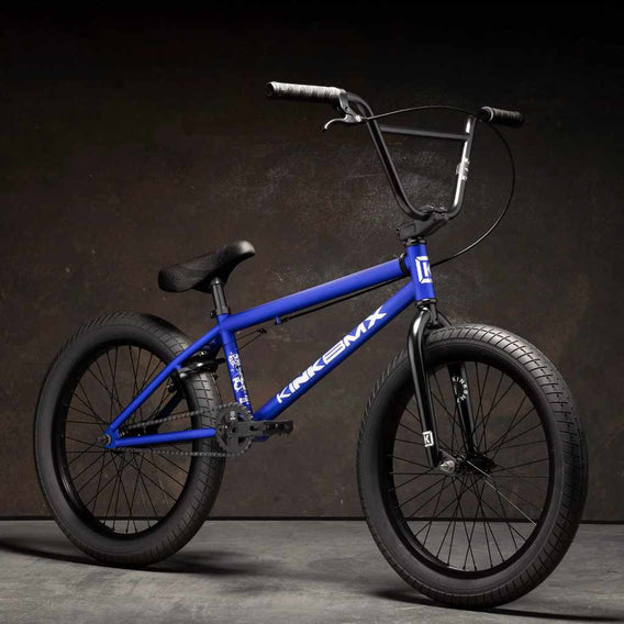 Kink Curb 20 inch BMX bike in Cobalt blue photographed at a 45 degree angle in an industrial warehouse