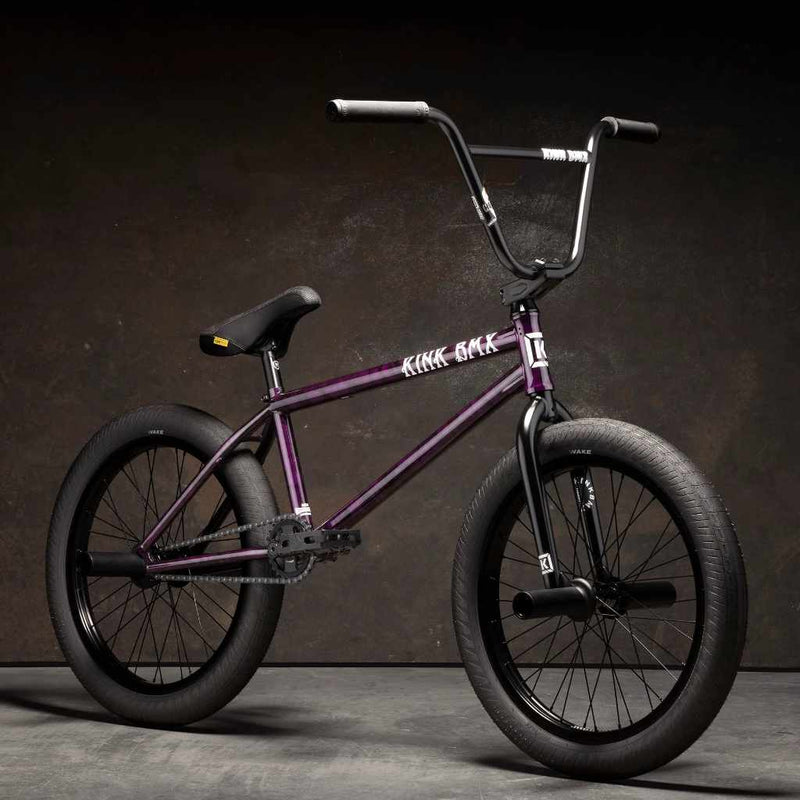 Kink Downside 20 inch BMX bike in hazy purple photographed at a 45 degree angle in an industrial warehouse