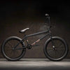 Side view of Kink Gap 20 inch BMX bike in midnight black photographed in an industrial warehouse