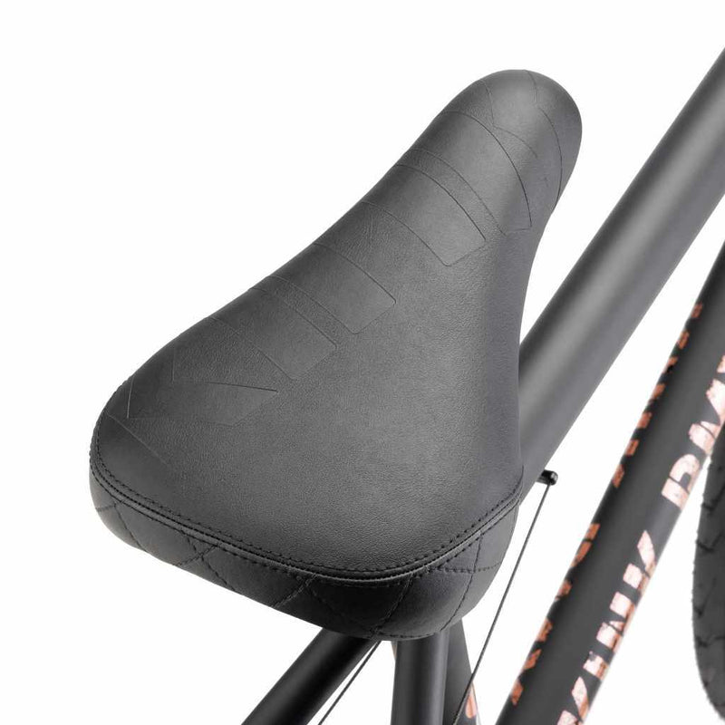 Close up of Kink Plymouth/Bomber Stealth Pivotal seat on a midnight black Kink Gap BMX bike