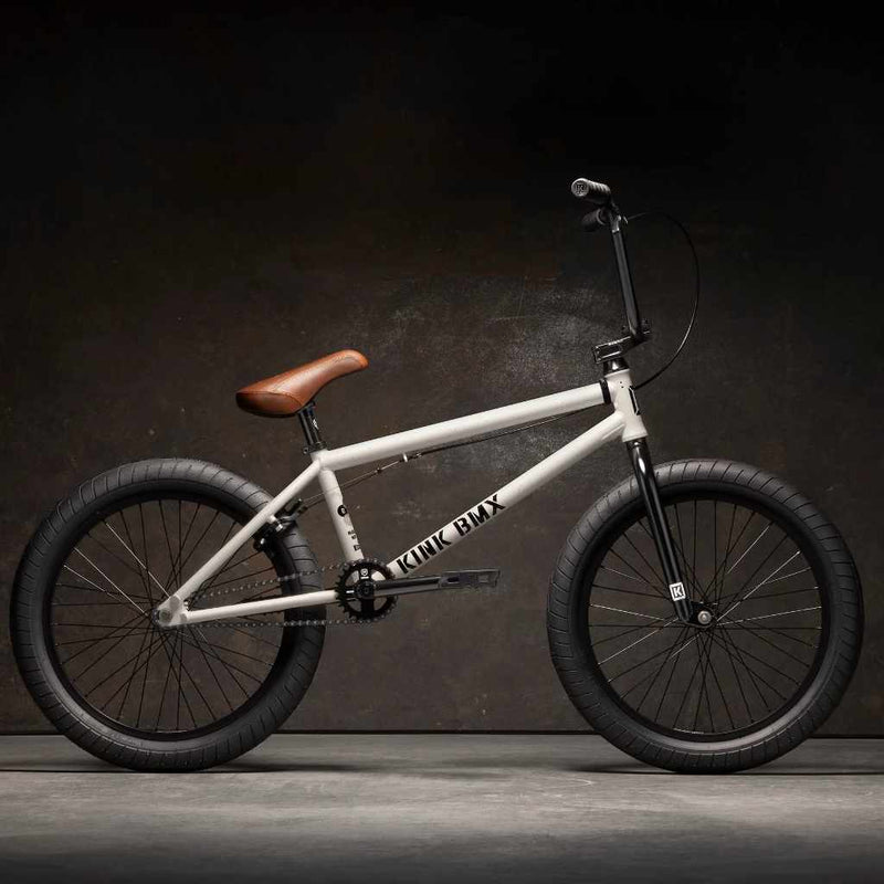 Side view of Kink Gap 20 inch BMX bike in Terrazzo White photographed in an industrial warehouse