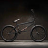 Side view of Kink Gap XL 20 inch BMX bike in midnight black photographed in an industrial warehouse
