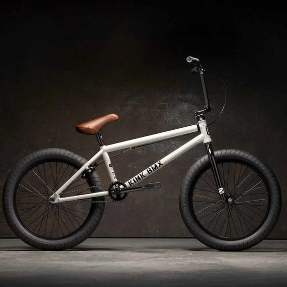 Side view of Kink Gap XL 20 inch BMX bike in Terrazzo White photographed in an industrial warehouse