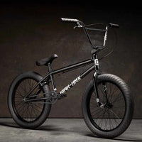 Kink Launch 20 inch BMX bike in midnight black photographed at a 45 degree angle in an industrial warehouse