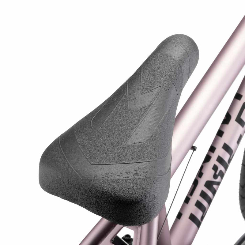 Close up of Mission Warsaw Combo seat on platinum rose Kink Launch BMX bike