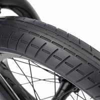 Close up of a black Mission Tracker 14" tyre assembled onto a Kink Pump BMX bike