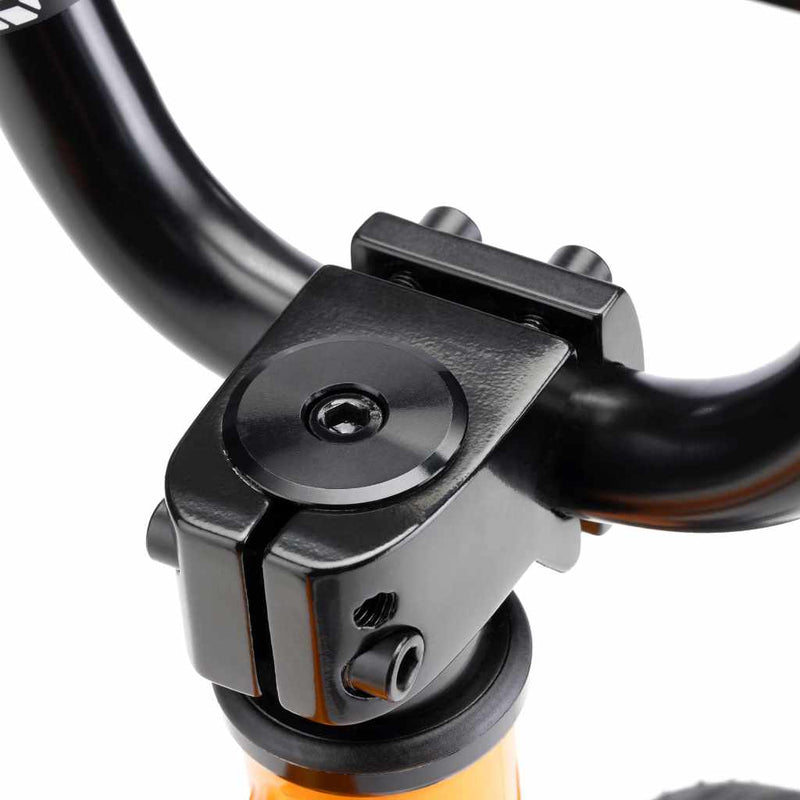 Close up photo of a BMX Mission front load stem in black assembled onto a Kink 12 inch Roaster BMX bike