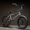Kink Whip 20 inch BMX bike in slate grey photographed at a 45 degree angle in an industrial warehouse