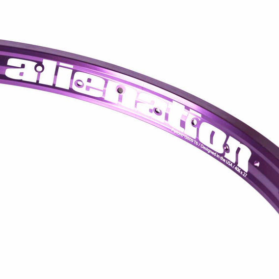 Close up of a Purple Alienation TCS Felon rim showing the Alienation graphic in white. Photographed on a white background