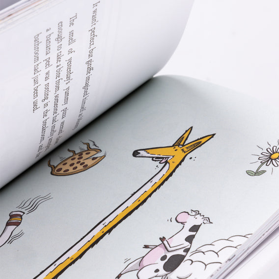Open book with illustrations of a giraffe, flower, and other elements on a white background