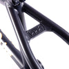 Close-up of a navy blue bicycle frame with a brand logo on a white background