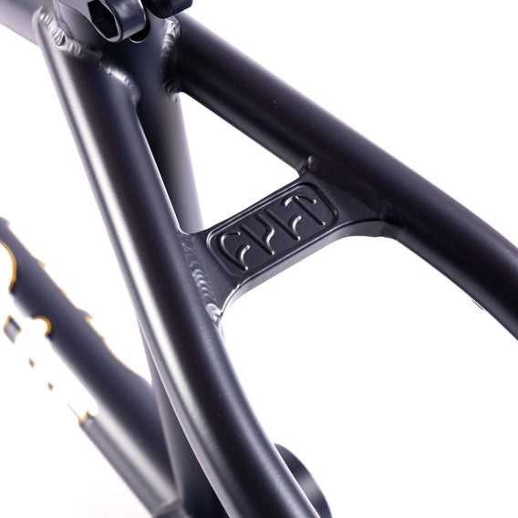 Close-up of a navy blue bicycle frame with a brand logo on a white background