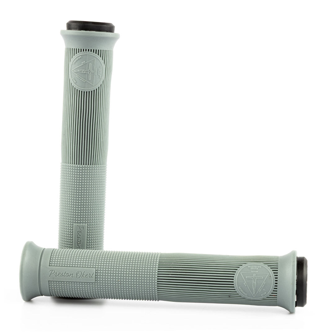 Pair of light gray bicycle handlebar grips with a textured pattern on a white background