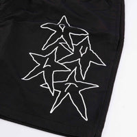 Black shorts with white star designs on a white background