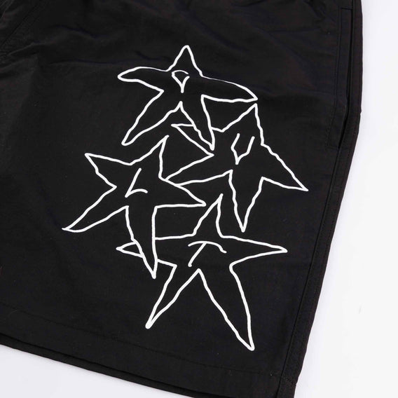 Black shorts with white star designs on a white background