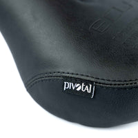 Close-up of a black leather seat with 'Pivotal' branding on a white background