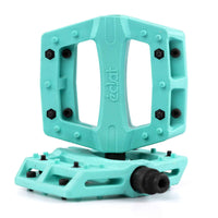 Turquoise Teal Eclat Contra BMX pedal with black pins on a white background