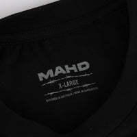 Black fabric with 'MAHD' branding and text on a dark background