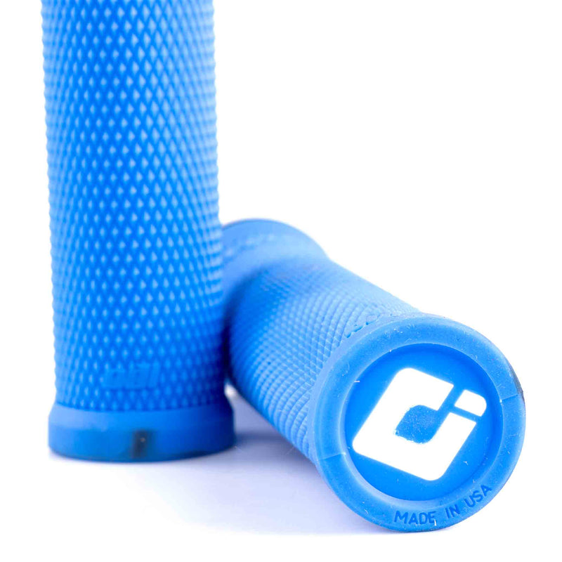 close up detail of the Blue textured odi ruffian grips with the ODI brand logo on the end on a white background