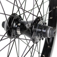 Close-up of a bicycle hub with visible branding on a white background