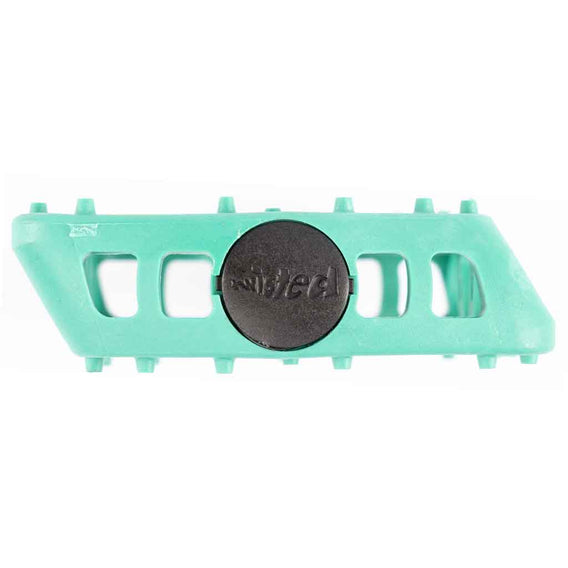 teal plastic bmx pedal with a black circular logo on a white background