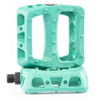 Teal bicycle bmx pedal with Odyssey branding on a white background