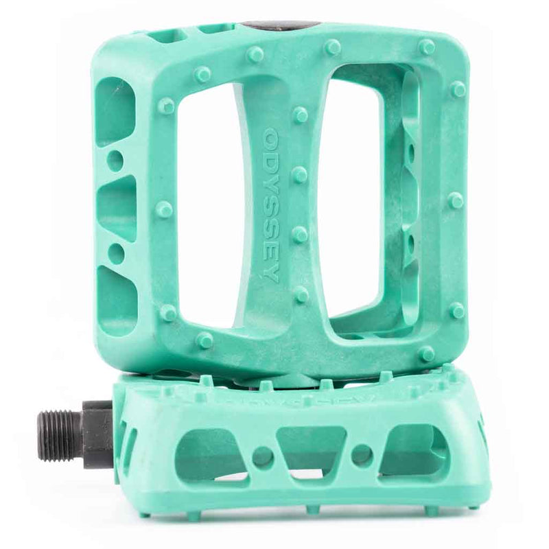 Teal bicycle bmx pedal with Odyssey branding on a white background