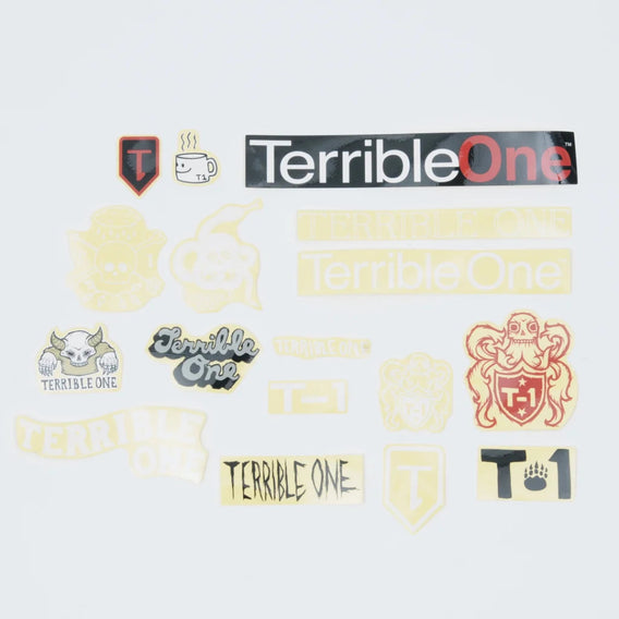 A collection of various 'Terrible One' themed stickers and decals displayed on a light gray background, including a large black and red logo sticker, a skull crest, a coffee cup, and several smaller graphic designs.