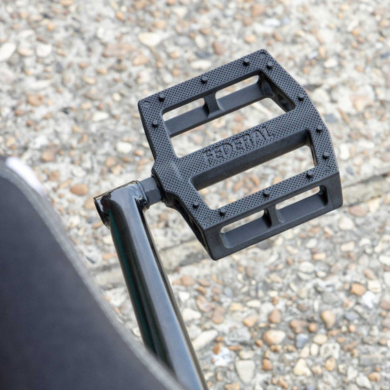 Black federal contact pedal on a textured ground background