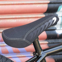 Close-up of a black bicycle seat with a blurred background
