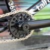 Close-up of a bicycle chain and gear system with blurred background