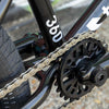 Close-up of a bicycle chain and gear system with '360' branding.