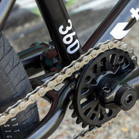 Close-up of a bicycle chain and gear system with '360' branding.