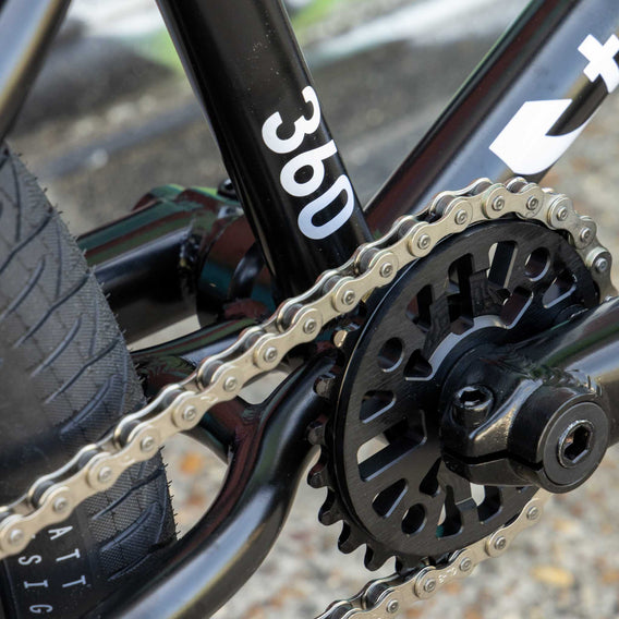 Close-up of a bicycle chain and gear system with '360' branding.