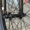 Close-up of a bicycle wheel with visible hub and spokes.