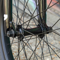 Close-up of a bicycle wheel with visible hub and spokes.