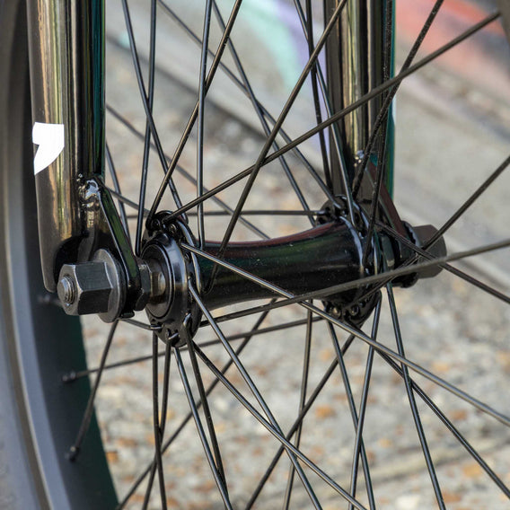 Close-up of a bicycle wheel with visible hub and spokes.