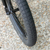 Close-up of a bmx subrosa matt real designer tire with tread pattern on a gravel surface
