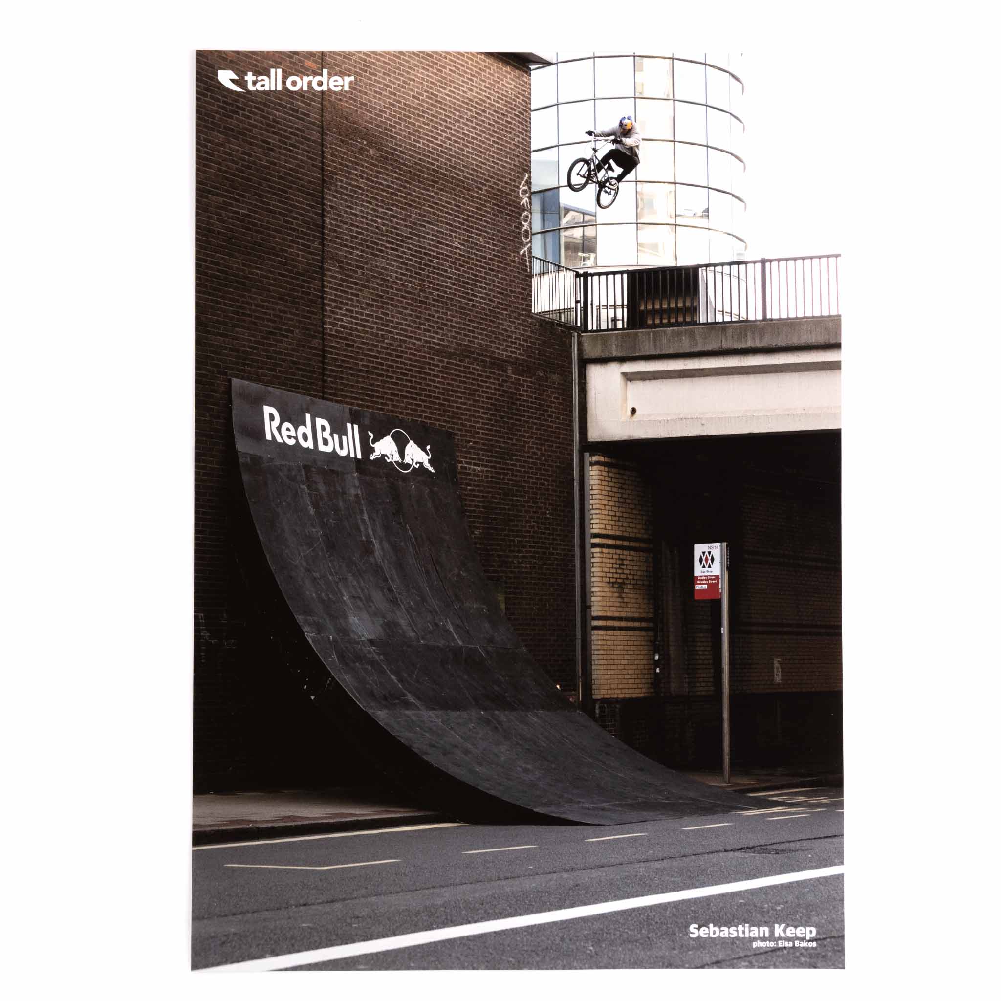 Sebastian Keep performing a trick on a ramp with 'Red Bull' and 'Tall Order' logos.