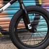 Close-up of a bicycle wheel with a colorful background