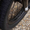 Close-up of a cult bmx wheel on a textured pavement surface