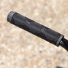 Close-up of a black tall order catch handlebar grip on a blurred concrete background