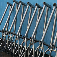 Total BMX Killabee Titanium Frame - Raw stacked on wall