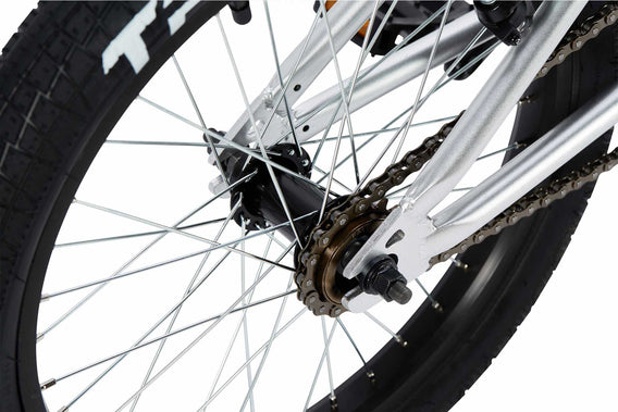 Tribal Nomad 18" BMX in Silver, close up of rear tyre and hub photographed on a white background
