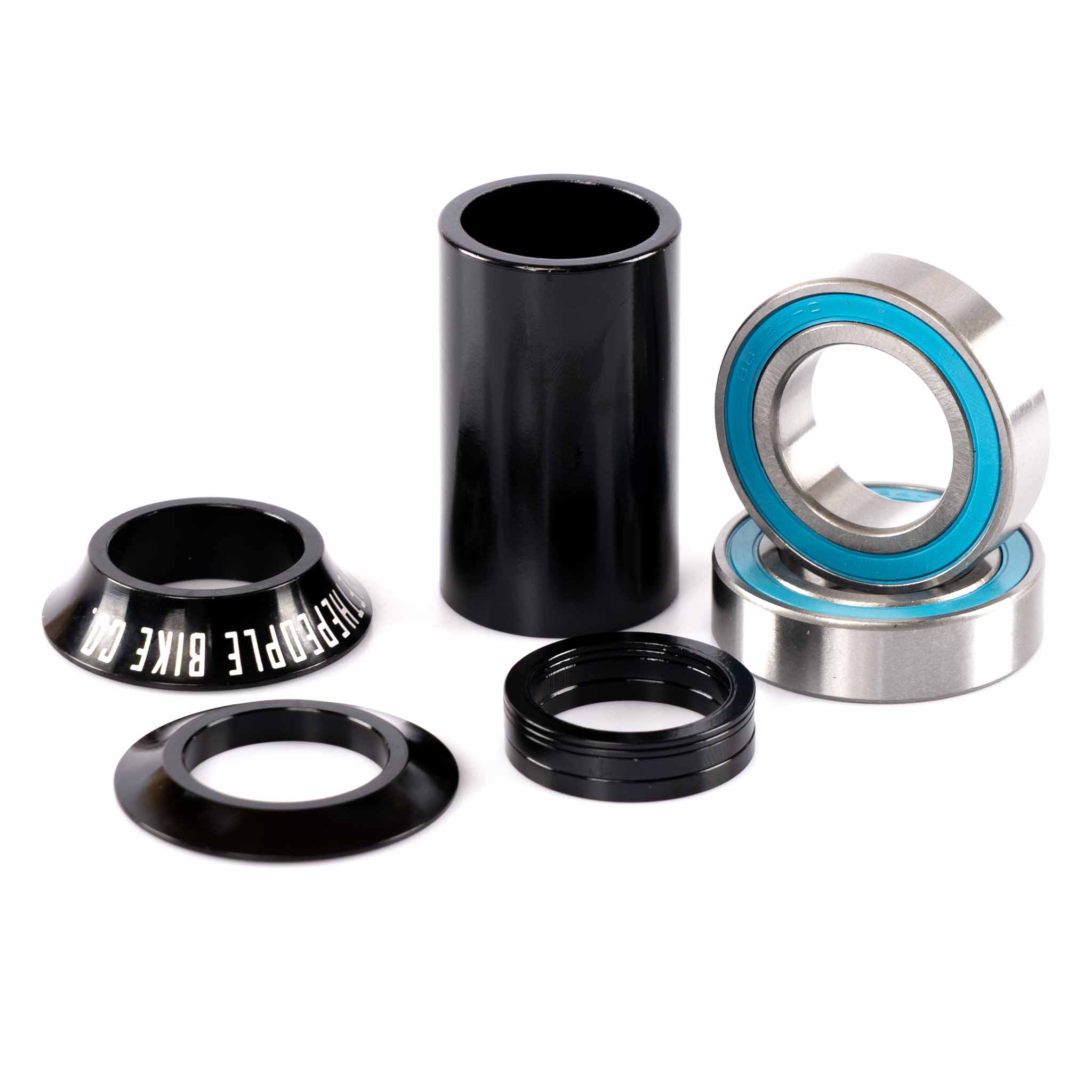 Bicycle headset components including black cups and bearings on a white background